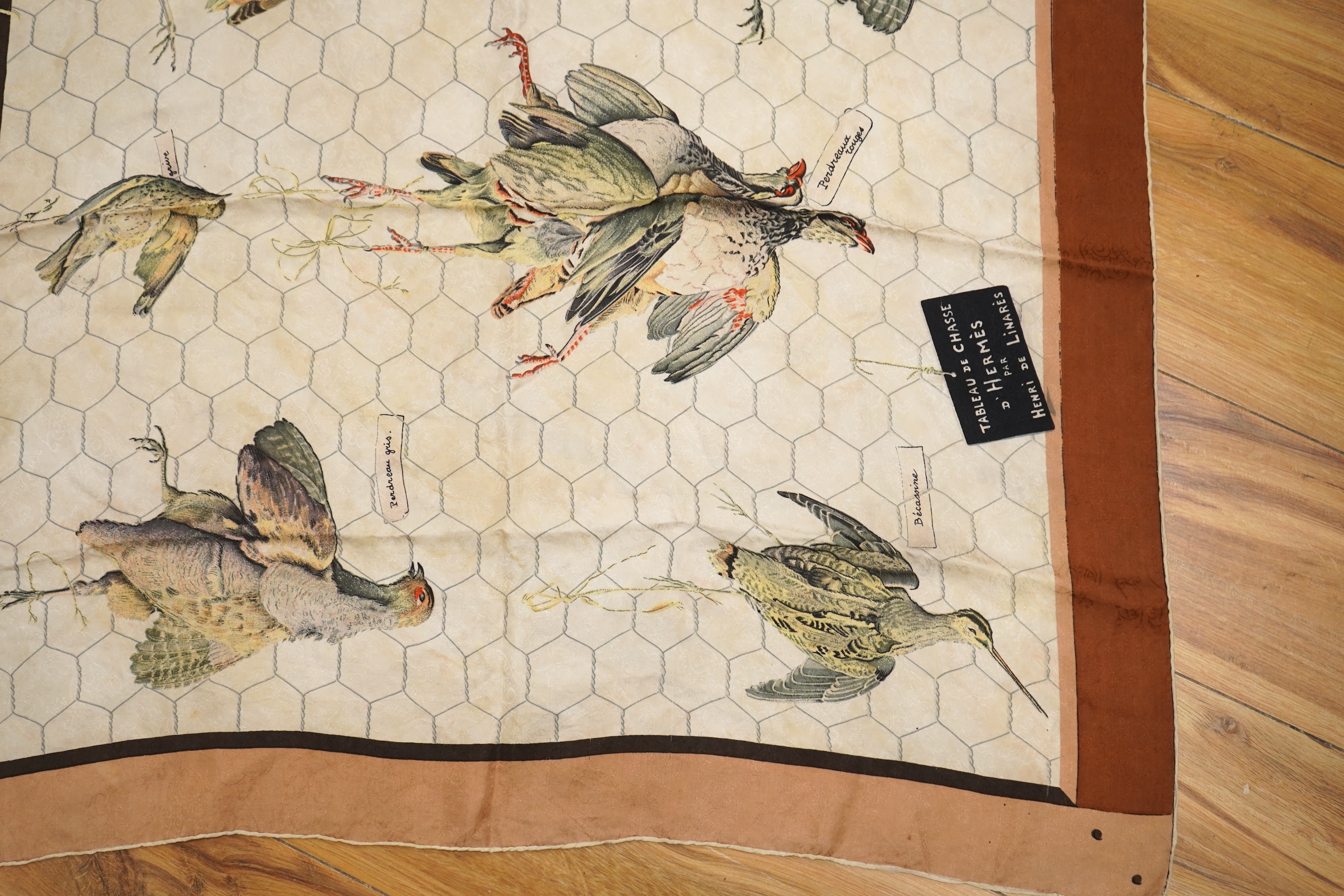 A collection of three Hermes silk scarves and a Chanel monogram example